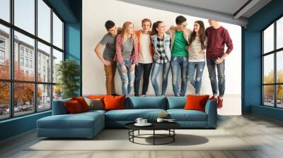 Group of cute teenagers near white wall Wall mural