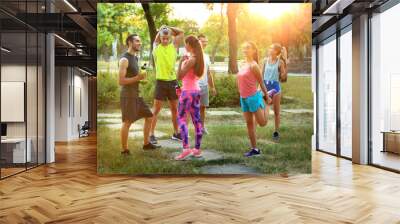 Group of young sporty people outdoors Wall mural