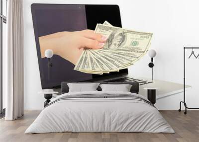 Hand giving money from laptop screen isolated on white Wall mural