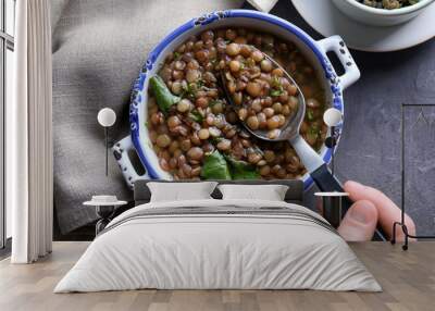 hand of woman eating tasty lentil dish, closeup Wall mural