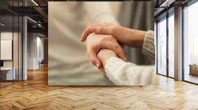 Hands of young woman countenancing depressed friend, closeup Wall mural