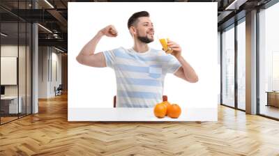 Handsome man posing with juice on white background Wall mural