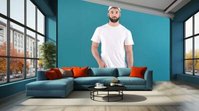 Handsome young man in stylish white t-shirt on color background. Mockup for design Wall mural