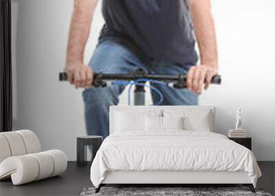 handsome young man riding bicycle on white background Wall mural