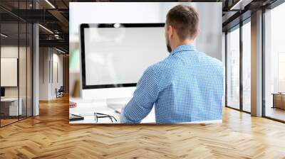 Handsome young programmer working in office Wall mural