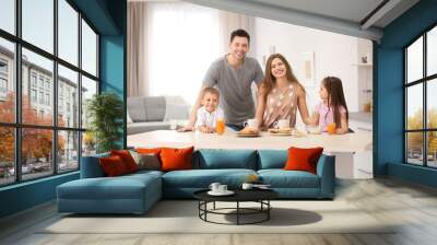 Happy family having breakfast in kitchen Wall mural