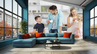 Happy family having breakfast on kitchen Wall mural