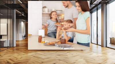 Happy family having breakfast with toasts in kitchen Wall mural