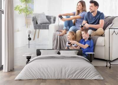 Happy family playing video games at home Wall mural