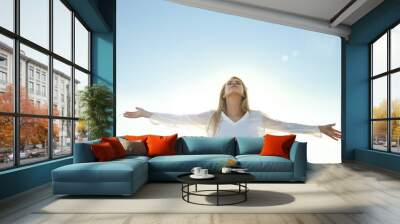 Happy young woman on sky background Wall mural