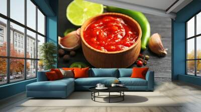 Homemade hot sauce and spices on dark wooden background Wall mural