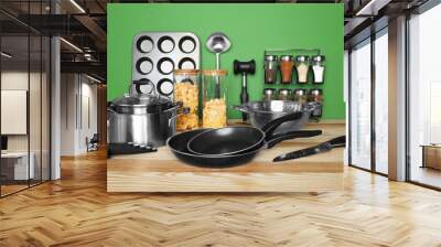 Kitchen utensils and cookware for cooking classes on wooden table Wall mural