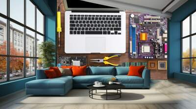 Laptop and different electronic circuits, tools on wooden table, top view Wall mural