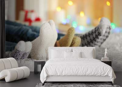 Legs in colorful socks on white carpet background Wall mural