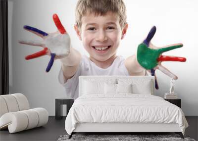 Little boy with hands in colorful paints isolated on white Wall mural