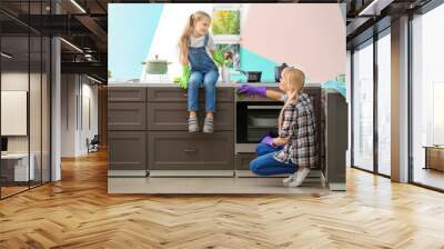 Little girl and her mother cleaning up in kitchen Wall mural