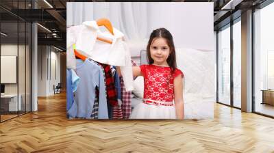 Little girl trying on a new dress Wall mural