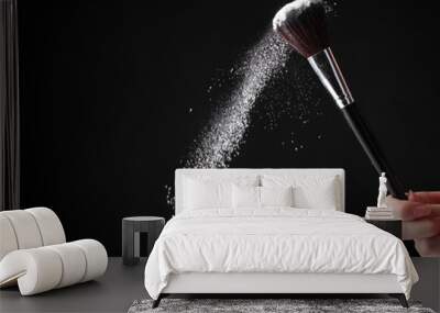 Make up brush with powder on black Wall mural