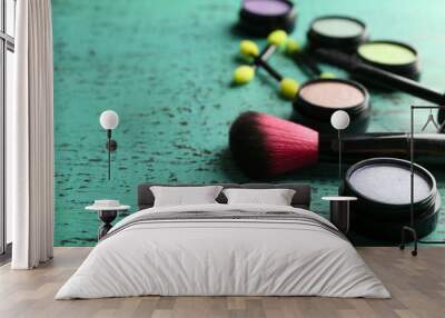 Make up powder and brushes on wooden table closeup Wall mural