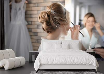 Makeup artist preparing bride before her wedding in room Wall mural