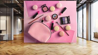 Makeup products with cosmetic bag and macaroons on color background Wall mural