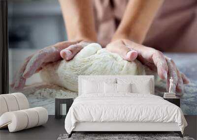 Making dough by female hands at bakery Wall mural