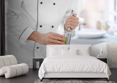 Male hands decorating fruit tarts with lime zest Wall mural