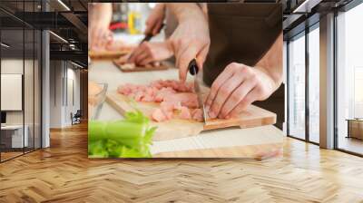 man cutting chicken fillet at cooking classes Wall mural