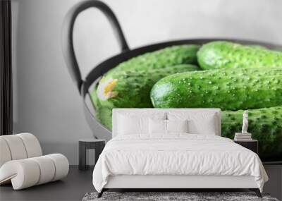 Many green fresh cucumbers in metal basket, closeup Wall mural