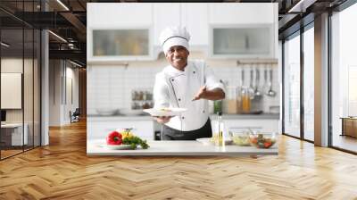 Mature Indian chef cooking in kitchen Wall mural