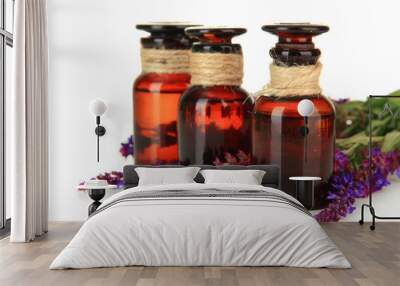 Medicine bottles and salvia flowers, isolated on white Wall mural