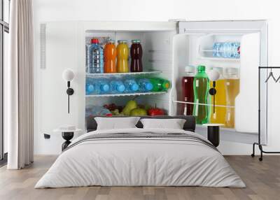 mini fridge full of bottles of juice, soda and fruit isolated Wall mural