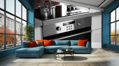 Modern electric stove with utensils in the kitchen Wall mural