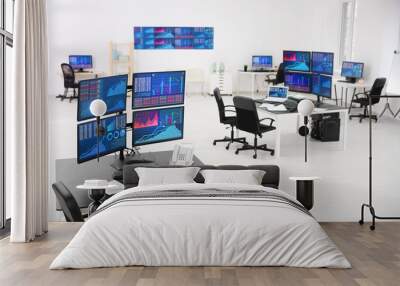 Monitors with stock data on table in office Wall mural