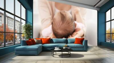 Mother holding cute baby on her knees, closeup Wall mural