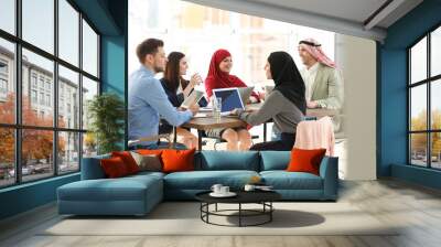 Office employees and their Muslim coworkers having business meeting in office Wall mural