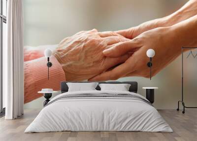 Old and young holding hands on light background, closeup Wall mural