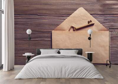 Old key with envelope on wooden background Wall mural