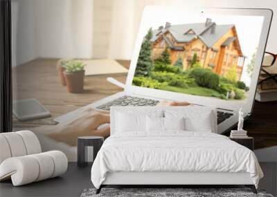 Online shopping concept. Woman looking for house on real estate market website Wall mural