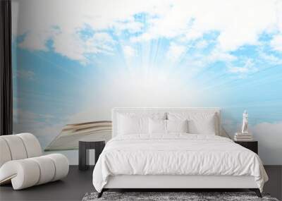 Opened book on sky background Wall mural