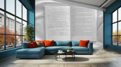 opened book on white crumpled sheet Wall mural