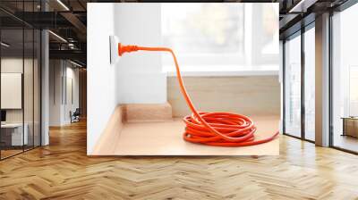 orange extension into power outlet indoors Wall mural