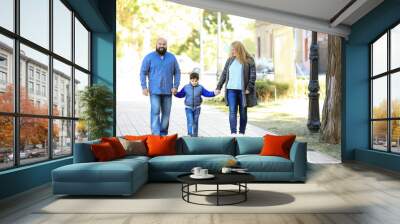 Overweight couple with son in park Wall mural