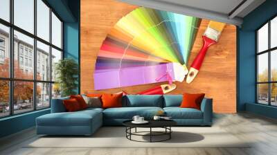 paint brushes and bright palette of colors on wooden background Wall mural