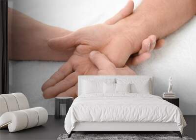 Physiotherapist giving hand massage to senior patient, closeup Wall mural