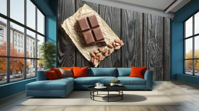 Piece of chocolate and cocoa beans on table Wall mural