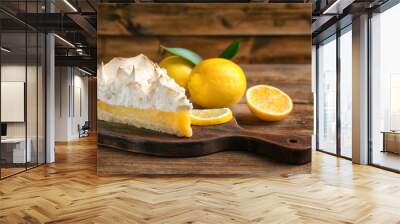 Piece of yummy lemon meringue pie on wooden table Wall mural