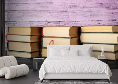 Pile of books on wooden background Wall mural