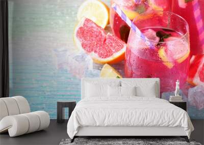 Pink lemonade in glasses and pitcher on bright background Wall mural