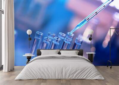 Pipette dropping a sample into a test tube, closeup Wall mural